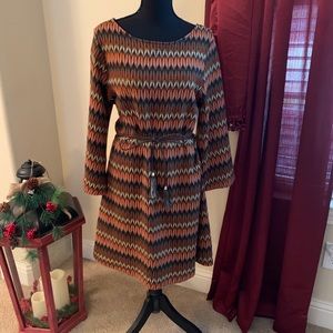 Adorable dress with leather-like fringe belt.